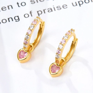 Detail of gold heart earrings with pink and white cubic zirconia and snap closure