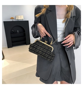 Chic black plaid tweed shell bag with gold handle shown as a handheld and crossbody style