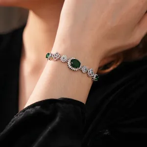 Vintage zircon flower sun bracelet with large oval green gemstone on a silver band