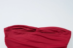 Detailed texture of wine red ruched fabric on a sexy twist front bandeau summer top