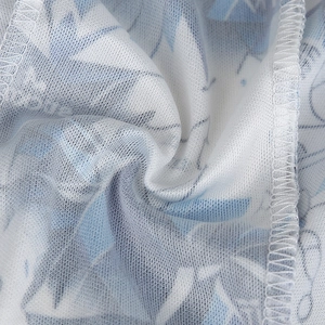 Close-up of breathable mesh fabric with blue ink floral pattern and neat stitching edges