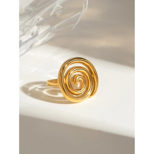 Detail of 18k gold plated stainless steel twisted spiral ring on white geometric stand