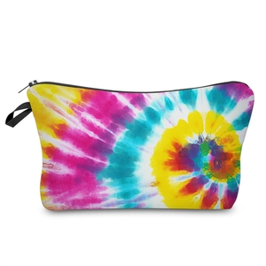 Detail of a vibrant tie-dye makeup bag with a black zipper and side handle loop