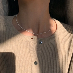 Elegant S925 sterling silver shimmering sand necklace shown on model neck