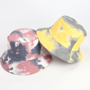 Close-up of tie-dye bucket hats in yellow-grey and red-grey patterns with durable twill cotton