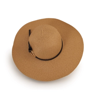 Close-up of wide-brimmed straw hat featuring a black leather band and golden metal buckle