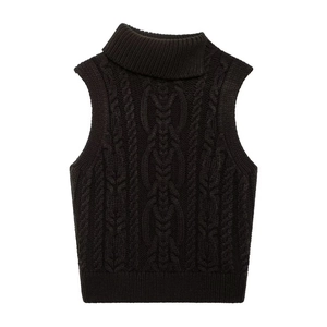 Close-up of black high-neck knitted vest showing detailed chunky cable knit texture