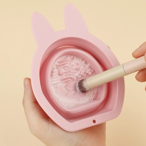 Pink rabbit-shaped silicone makeup brush cleaning bowl with textured scrubbing surface