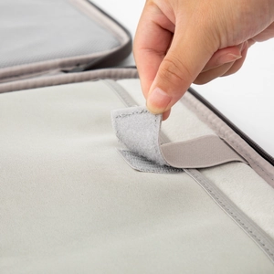 Detail view of the gray tablet bag interior featuring elastic straps and velcro closure