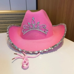 Detail of pink cowgirl hat featuring a rhinestone tiara and silver sequin trimmed brim