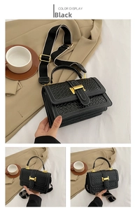 Detail of black woven leather handbag with golden H-buckle and colorful woven strap