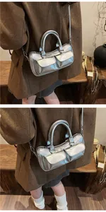 Detail of silver metallic cylinder bag with dual magnetic pockets and adjustable strap