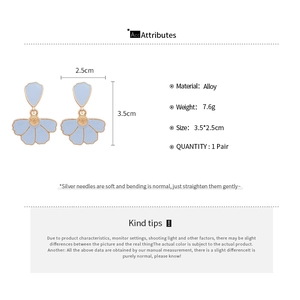 Detail view of light blue flower petal earrings with alloy size and weight specs