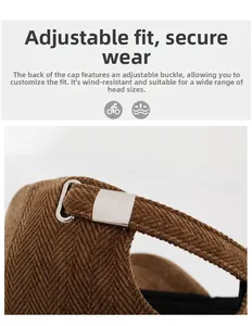 Detailed view of the adjustable silver metal buckle on brown herringbone fabric hat