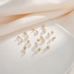 Elegant 925 sterling silver freshwater pearl stud earrings in various sizes on tray