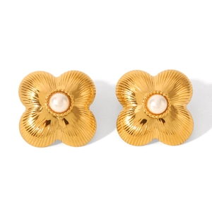 Detailed close-up of golden floral stud earrings featuring textured petals and a white pearl