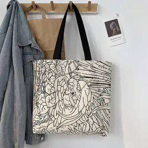 Illustrazione artistica di angelo su borsa tote in tela con tracolla nera