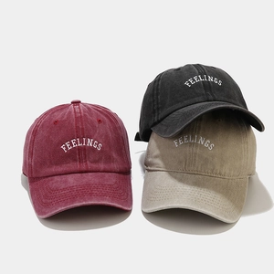 Detail of Feelings letter embroidery on vintage washed cotton baseball caps in three colors