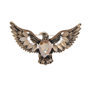 Vintage eagle brooch with bronze finish, champagne teardrop stone and white cat-eye gems