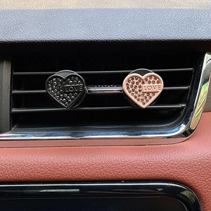 Detail of pink and black diamond heart car air vent clips with LOVE engraving