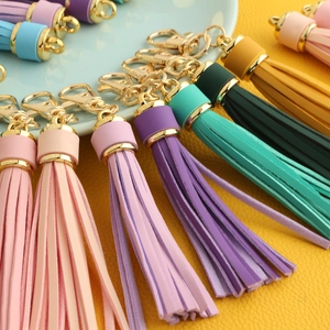 Macro shot of colorful PU leather tassels with golden alloy lobster clasps for keychains
