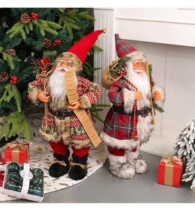 Detailed view of standing Santa Claus figurines with knitted clothes and holiday accessories