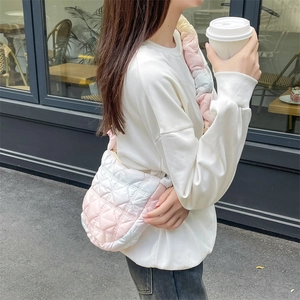 Pink gradient quilted cloud bag with ruffled strap styled for casual street wear fashion