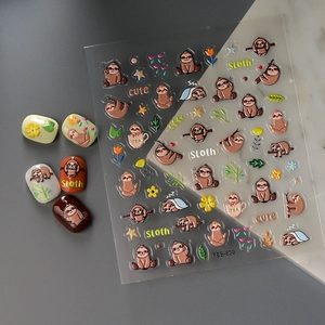 Detail of 3D cartoon sloth nail stickers with flowers and stars on manicured nails