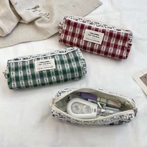 Detailed view of large capacity plaid pencil case showing stationery storage with lace trim