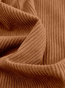 Macro shot showing the soft corduroy fabric texture and ribbed pattern in caramel brown