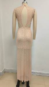 Détail de la robe de soirée dos nu abricot avec strass brillants et tissu en maille
