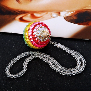 Close-up of a sparkling rainbow rhinestone car ornament with a faceted crystal bead chain