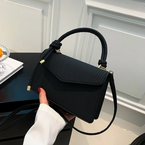 Minimalist black woven texture crossbody bag with gold hardware and top handle for women