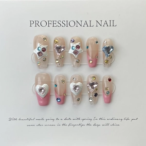 Detailed view of handmade press-on nails with 3D heart rhinestones and star crystals