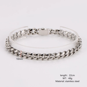 Detail shot of 10mm wide silver stainless steel cuban link bracelet on display stand