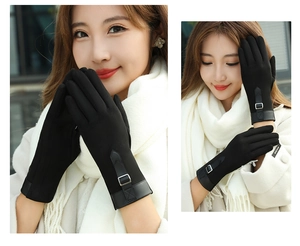 Close-up of black suede winter gloves for women featuring touchscreen fingers and wrist buckle