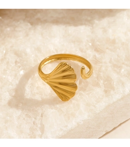 Macro shot of gold leaf-shaped open ring on decorative white crystal stones