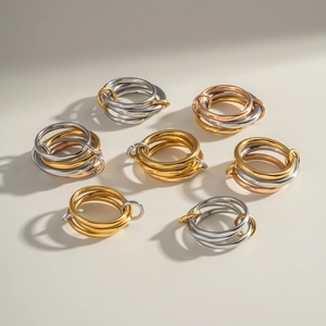 Minimalist interlocking stainless steel rings in gold, silver, and rose gold finishes