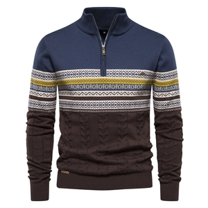 Detail of half-zip knit sweater with geometric ethnic patterns and cable textures