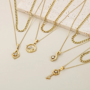 Close-up of gold layered necklace set with diamond-encrusted heart and unicorn pendants