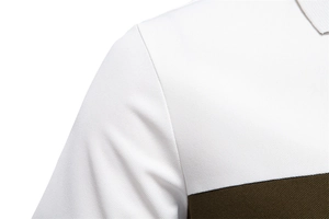 Detail of piqué fabric texture and color block stitching on a men's polo shirt