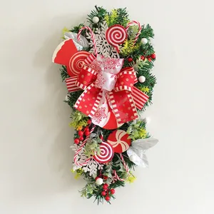 Detailed close-up of Christmas upside-down tree swag with red bows and candy canes