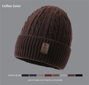 Close-up of coffee brown cable knit beanie with thick fleece lining and leather label