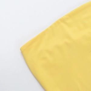Detailed macro shot showing fine stitching and yellow knit fabric texture on the waistline