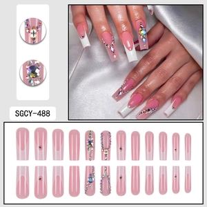 White French press on nails with glitter diamonds and pearl accents long coffin shape