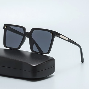 Oversized square black sunglasses with metal studs and leather case