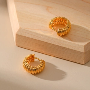 Detail shot of vintage 18K gold plated hoop earrings with textured spiral rib design