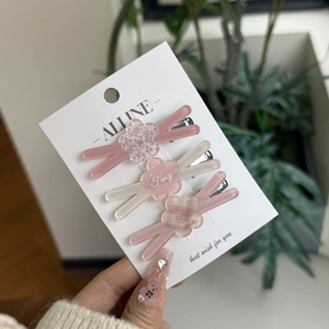 Set of three pink floral and cream acrylic hair clips with fancy and love lettering