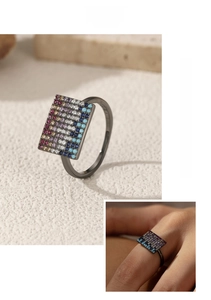 Macro detail of rectangle black plated silver ring with gradient pavé colored zircons