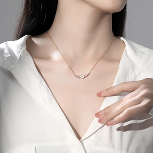 Elegant S925 silver flower necklace in rose gold finish worn by model on white shirt